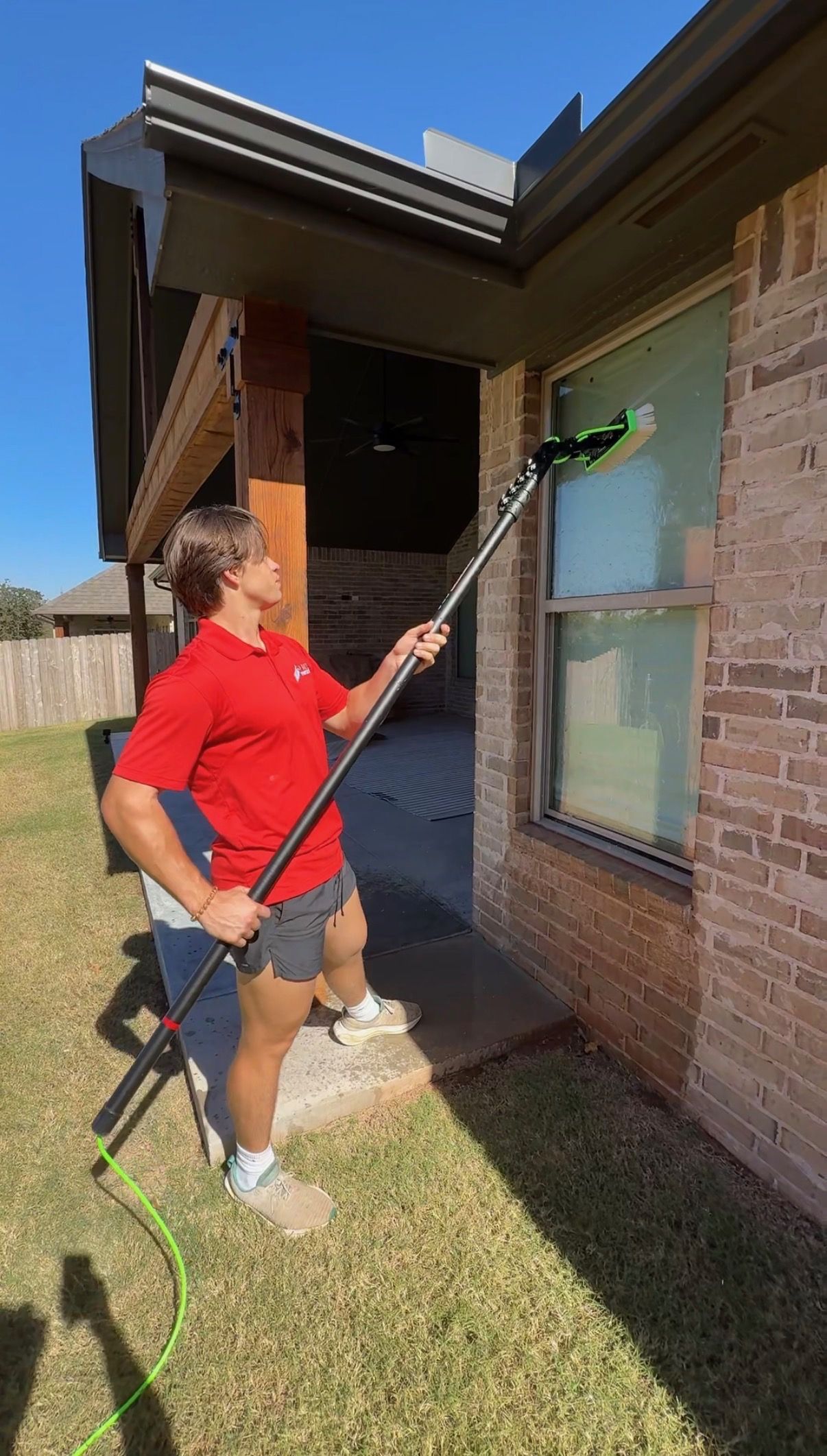 Pane Protector technician cleaning a window with a water-fed pole