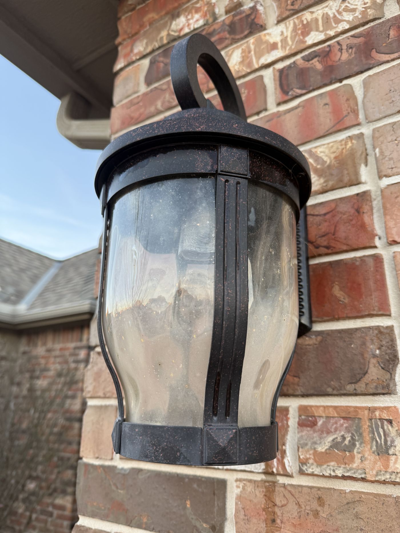 Outdoor light fixture before cleaning, dusty and spotted